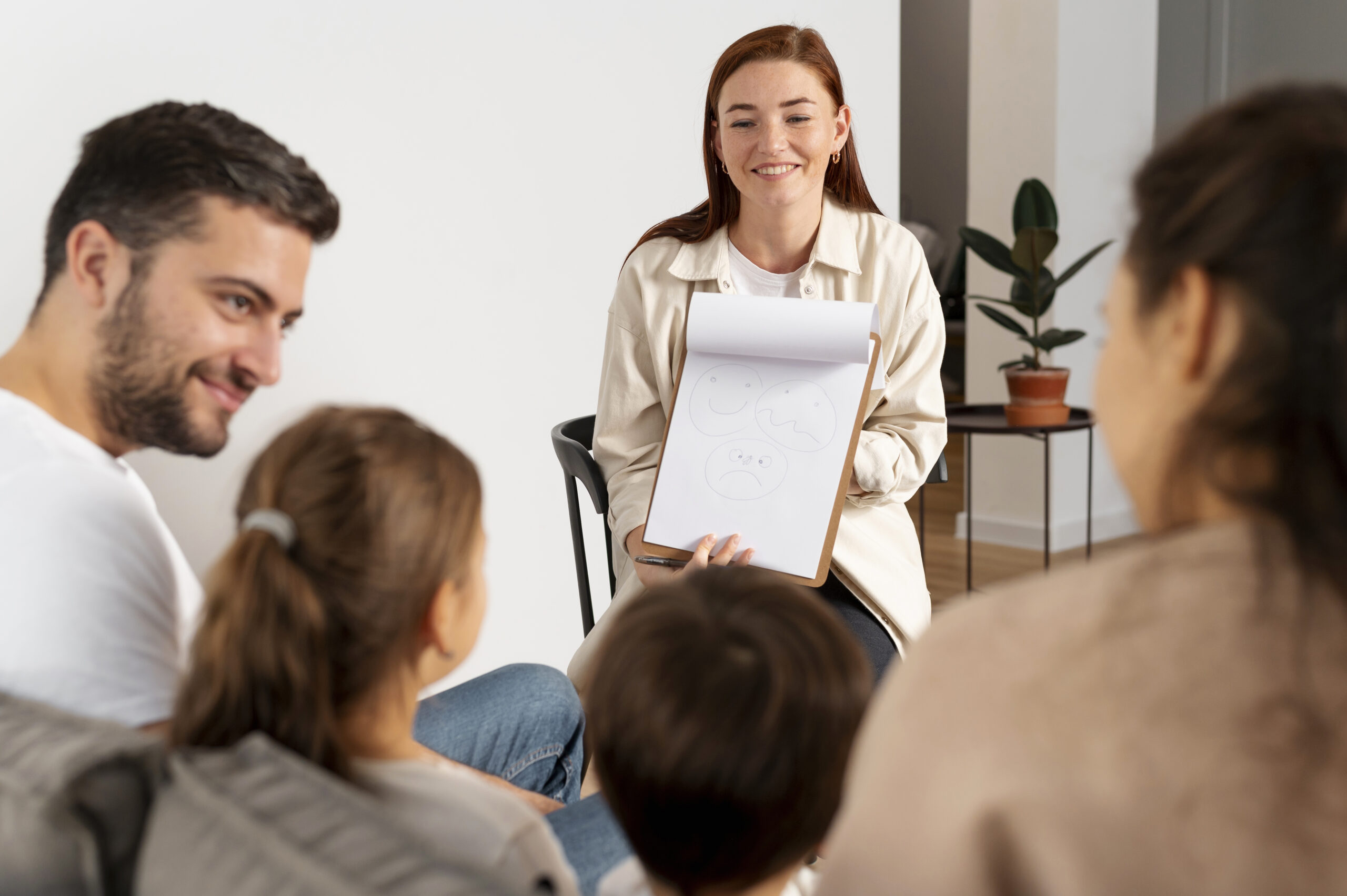 close-up-family-members-talking-therapist